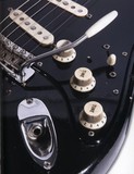 Mini toggle switch between the volume knob and pickup selector.