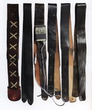 Accessories to black.
Straps. A selection of guitar straps used by David on the Black Strat since 1974. Note: The brown Jimi Hendrix strap pictured on the left and a 1977 
Schaefer Vega wireless transmitter first used for The Wall shows.